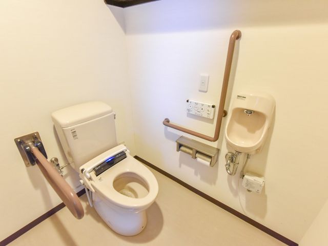 バリアフリートイレ設備 トイレ サポートが必要な方も使用しやすい手すり付きのトイレです。安心して快適にご利用いただける環境を整えています。