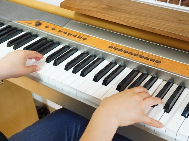 エレクトーンを弾く手 共有スペース 手のひらでやさしく音を奏でる様子が印象的です。音楽に触れ合える環境が、日々の豊かさに寄与しています。