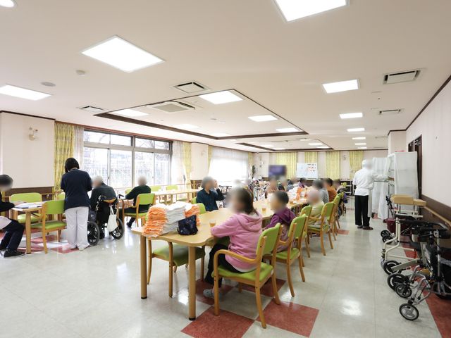 共有ダイニングエリア 共有スペース 広々とした食事エリアで利用者が穏やかに過ごしています。明るい空間は日々の暮らしに彩りを添えています。