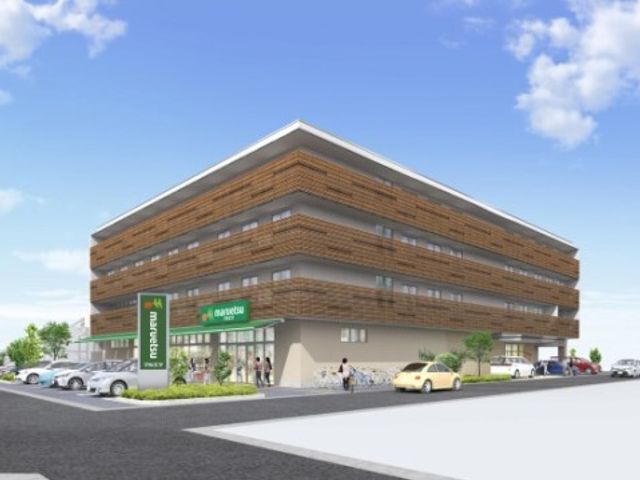 明るい外観の建物 外観 開放感のあふれる建物の入口付近では、来訪者が心地よくお迎えできる設計となっています。温かみを感じさせる色合いが特長です。