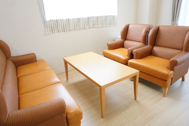 施設の写真 テーブルを挟んで大きなソファーが置かれている休憩スペース