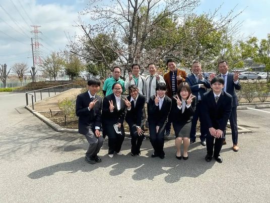 屋外で集まる職員と学生  