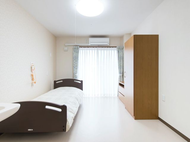 快適な居室 居室 ベッドと洗面台が備わった明るく清潔な個室です。窓からの自然光が日々の暮らしに温かさをもたらします。