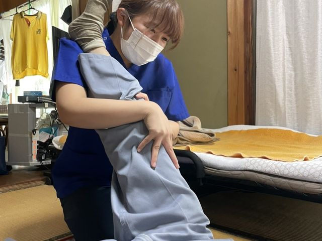 体操をサポートする様子 スタッフイメージ リハビリの支援が行われており、利用者の身体機能をサポートする環境が整っています。
