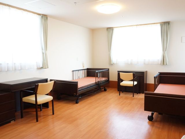 明るく広々とした居室 居室 落ち着いた色合いの家具が配置された居室です。ゆったりとした時間を過ごすのに適した環境が整っています。