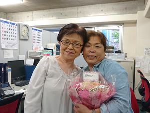 笑顔の2人と花束のフロント  