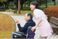 笑顔で車椅子を押す介護
