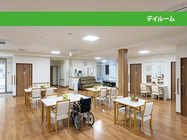 広い食堂と共有席のある空間 ダイニングルーム   木目調の床に、ゆったり配置されたテーブルと椅子が並ぶ明るい空間です。車椅子でも動きやすそうで、就業時の見通しも立てやすいです。