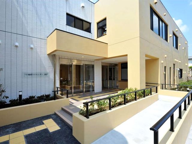 陽の光が差し込む建物の外観 外観 建物は落ち着いた色調で、広々としたエントランスが特徴です。訪れる方に安心感を提供するデザインです。