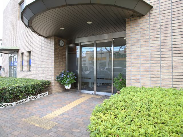 清潔感のあるエントランス エントランス１ アーチ型の屋根が特徴のエントランスは、訪れる人々を暖かく迎え入れます。