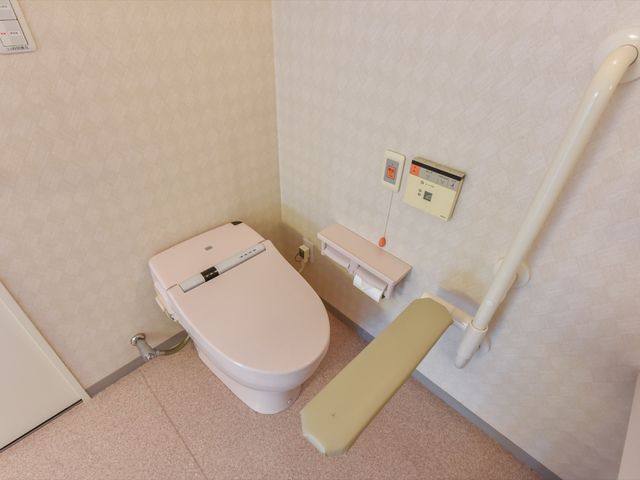 バリアフリートイレ設備 トイレ 安全に配慮されたトイレ設備で、手すりや緊急呼び出しボタンも整っています。利用者の安心と自立を支える環境が整えられています。