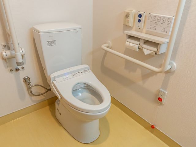 安全設備の整ったトイレ トイレ 手すりが設置されており、安全で利用しやすい空間です。安心して利用できる設備が整っています。