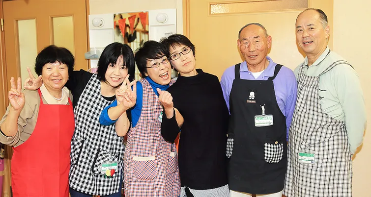 笑顔のスタッフと住民の集合写真