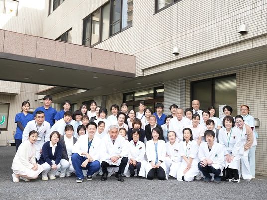 建物外観の前のスタッフ