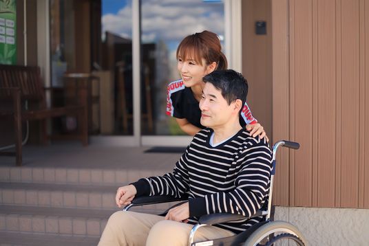 車椅子の男性と介護者のエントランス