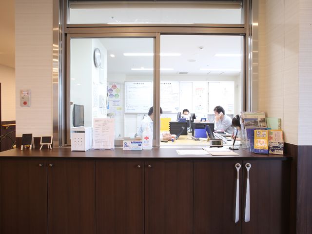 スタッフが働くカウンター 受付 快適な職場環境を提供するカウンターで、スタッフが業務に集中しています。フレンドリーな雰囲気で訪れる方をサポート。