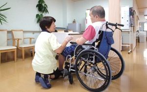 車椅子利用者とスタッフが対話する廊下