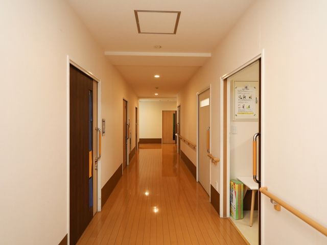 明るい廊下の様子 廊下 手すり付きの清潔感ある廊下が、安全で快適な職場環境を提供します。