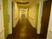 お部屋の扉の色は斬新なイエローグリーンである。幅が広めの引き戸で出入りが楽である。廊下は手すり付きなので安心である。