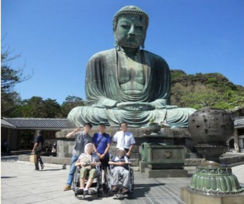 銅像前の笑顔の人々