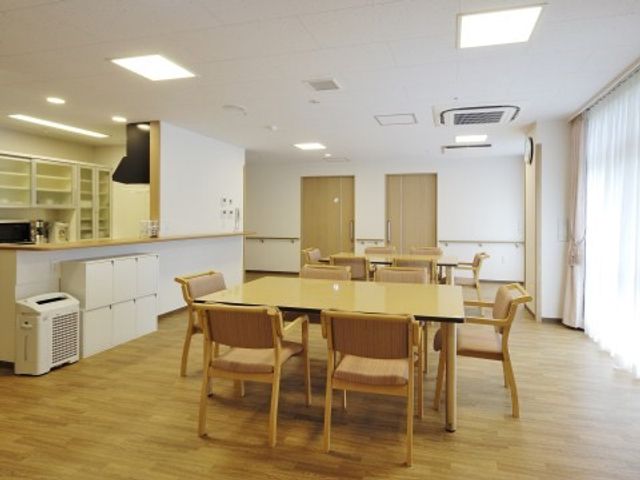 明るい共有ダイニングルーム リビング・ダイニング 広々とした清潔な食堂で、職員と利用者のコミュニケーションも活発に図れます。自然光が入る窓際は、ゆったりとした食事の時間を提供します。