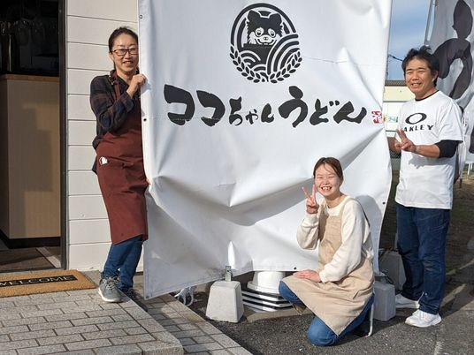 笑顔のスタッフと施設前  