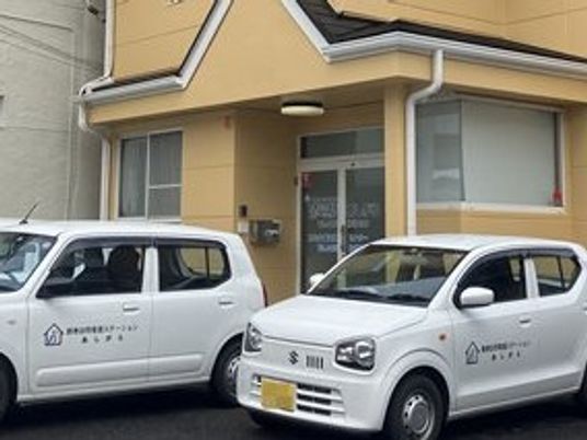 車が停まる建物外観  