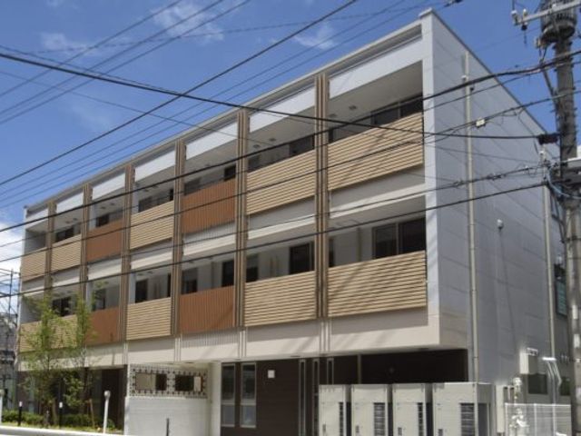 3階建ての建物外観 外観 明るい青空を背景にした三階建ての建物です。清潔感のあるデザインが魅力的です。