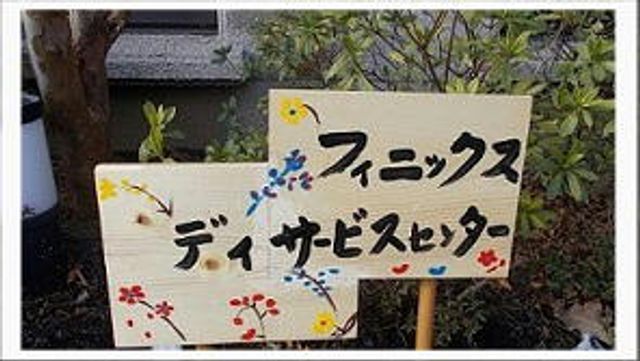 ガーデンの案内看板 看板 色とりどりの花が描かれ、明るい雰囲気の案内看板です。周囲の緑が心地良い空間を演出しています。