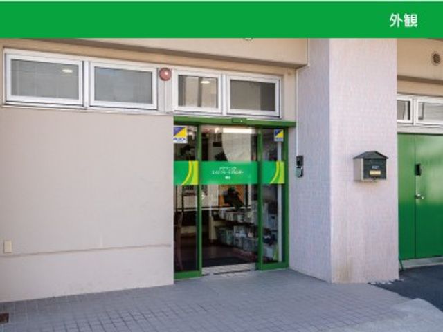 緑の入口がある外観 外観   緑色の出入口が印象的な建物の外観です。出入りしやすい正面口が見え、働く場の雰囲気をイメージしやすいです。
