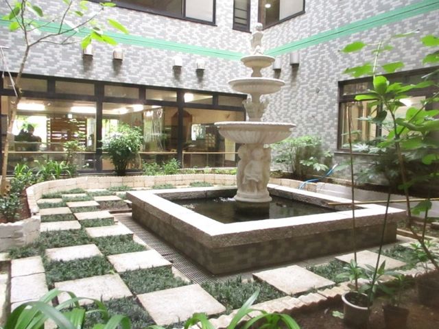 噴水と緑が映える中庭 中庭 噴水を囲む緑豊かな空間です。四季折々の自然を眺めながら、リラックスできる場所となっています。