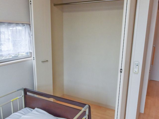 居室のベッドとクローゼット 収納 清潔感のある居室には、安全柵付きのベッドと開放感のある壁面収納が整っており、快適な生活空間をお約束します。