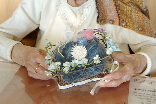 手作り花飾りを持つ手