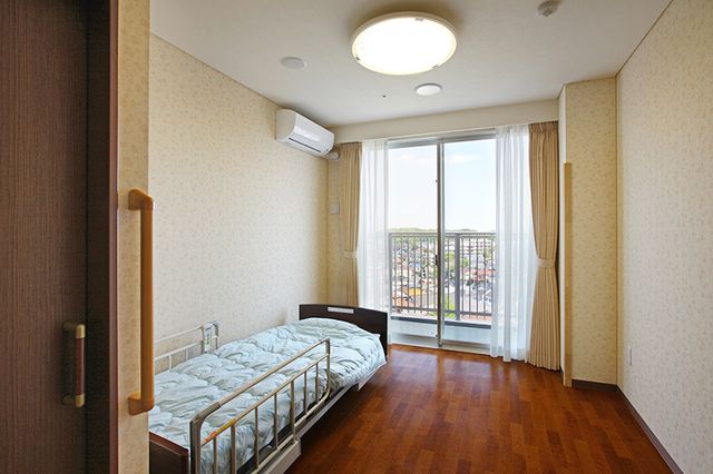 日当たりの良い居室 居室 大きな窓から自然光が差し込み、明るい室内です。木製の床で温かみを感じられます。