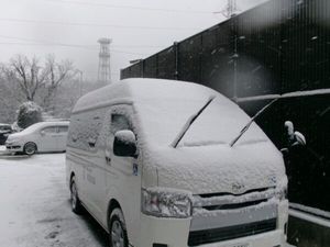 雪に覆われた送迎車の外観  