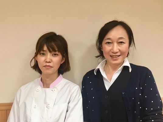 笑顔のスタッフ二人立ち姿