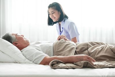 看護師と寝たきりの高齢者