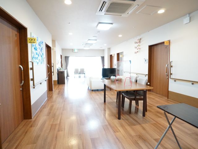 廊下の採光と居心地 廊下 床の木目調と優しい光が調和する廊下です。ここでスタッフや利用者の方々とのコミュニケーションも楽しめます。