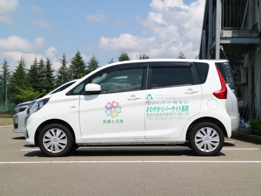 白いサービス車両と建物