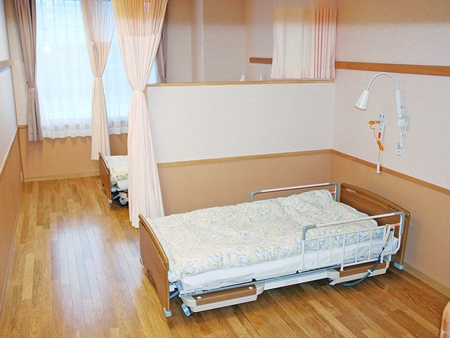ベッドが並ぶ居室 居室 木の温もりが感じられるベッドルームです。プライバシーを守るカーテンが設置されています。