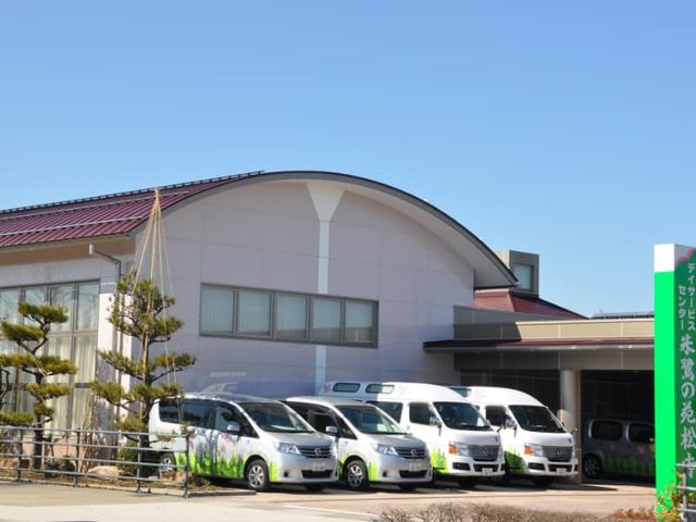 施設外観の駐車スペース 外観 明るい天気の下に広がる駐車場には、利用者の送迎車が整然と並んでいます。