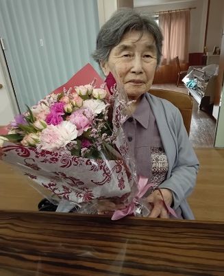花束を持つ高齢の女性