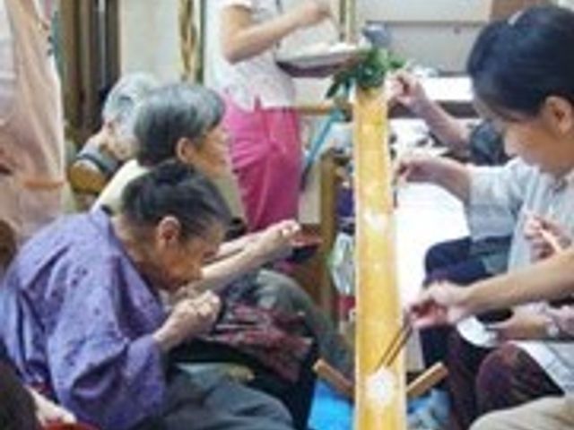 和やかな共有スペース スタッフが見守る中、和気あいあいと手作業を楽しんでいる皆さまの様子が伺えます。日々の暮らしに彩りを加える楽しい活動が盛んです。