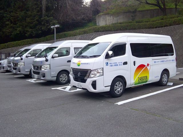 送迎車が並ぶ駐車場 外観 送迎用の車両が複数並んでおり、通いやすい環境づくりがうかがえます。車椅子マークの表示も見え、移動支援に配慮した様子です。