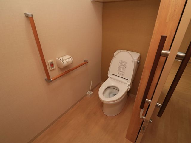 バリアフリートイレ トイレ 手すりを備えた清潔なトイレ空間。安全性を考慮し、利用者の快適さを追求した設計です。
