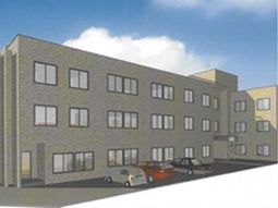 灰色の建物と駐車場