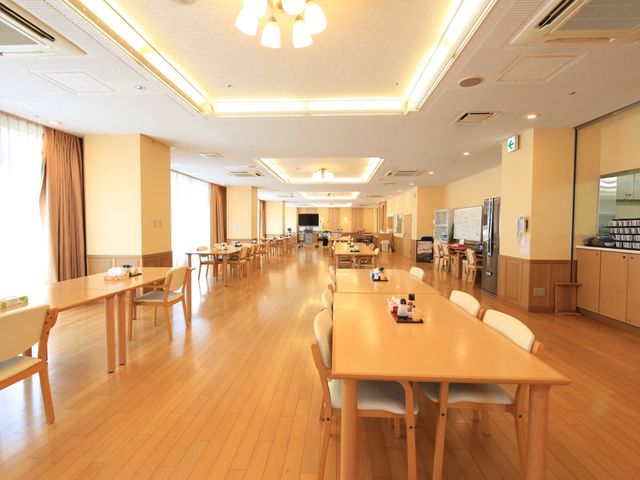 広々とした明るい食堂 食堂 温かみのある照明が特徴のダイニングルームです。十分な座席と落ち着いた雰囲気で食事ができ、くつろぎの時間を提供します。