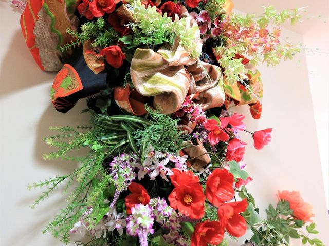 カラフルな装飾花束 掲示物 暖かみのある空間を演出する彩り豊かな花の装飾。利用者様の心を和ませる、入居者共有スペースの一角です。