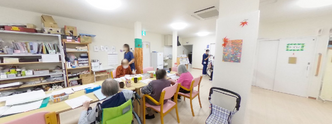 居間で過ごす入居者とスタッフ